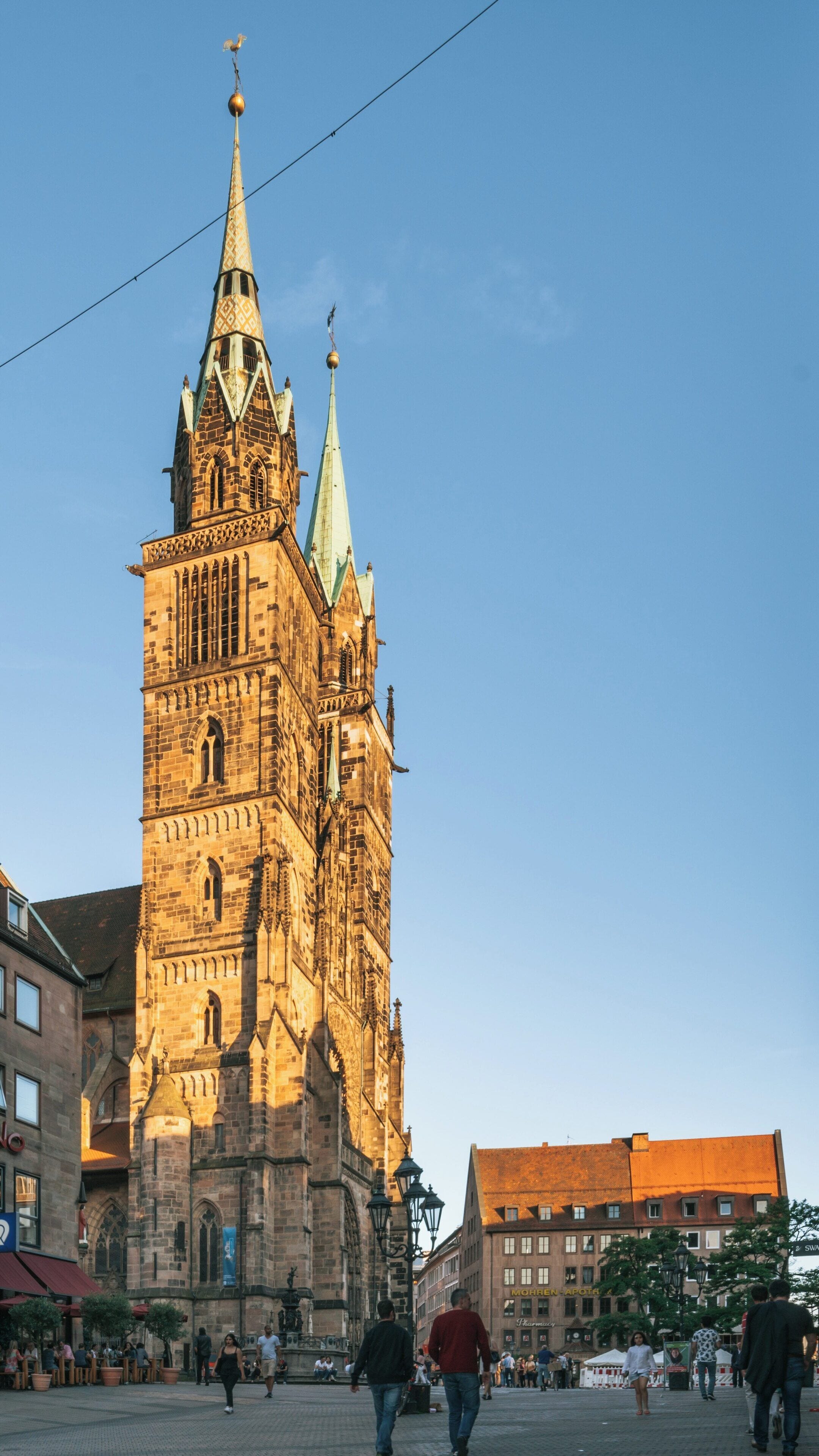 Exploring St. Lorenz Church in Nuremberg Old Town during a clear sky afternoon