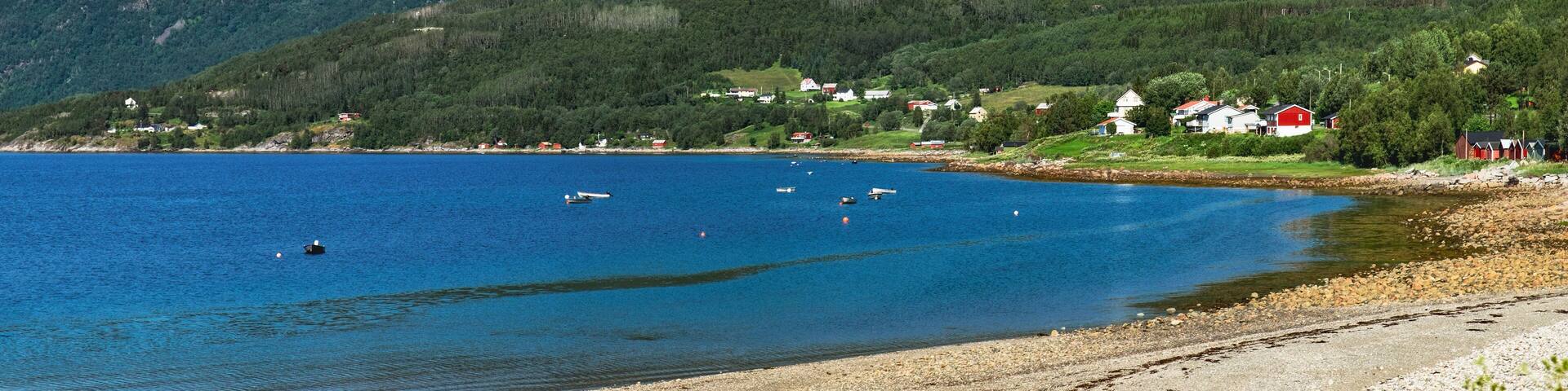 Panoramic view from Langstranda, the coast of Rombaken by the E6 road in Narvik municipality, Norway. Norwegian sea bay in summer scenery