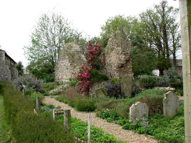 The Sacristy Garden. Perhaps the reason for there being two churches in close proximity to each other can be explained with the layout of paths and lanes, which may have made it convenient for worshippers of the two adjacent parishes to share a common churchyard. The former church of St Lawrence was gutted by fire in 1827 and after having been struck by lighning, its tower fell in 1971. The ruins have been restored and now serve as the parish hall. The ruined tower > 584395 is surrounded by a sacristy garden planted with herbs. For more detailed information see http://www.norfolkchurches.co.uk/swalshamlawrence/swalshamstlawrence.htm