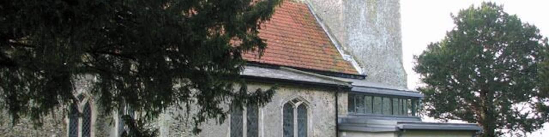 All Saints church - the new extension. All Saints church > 1692081 - 1692114 dates from the 14th century and is a Grade II listed building. Its south porch is a later addition dating from the 15th or early 16th century, and an extension built onto the north wall and providing modern facilities was completed in 2009. The church houses a number of medieval survivals, amongst them several wall paintings - one depicting St Christopher, another the Annunciation > 1692151. A very rare depiction of a group of women surrounded by three devils, dominated by Titivallus - the Demon of Gossip - is painted on the north nave wall, clearly meant as a warning against gossiping. The rood screen > 1692117 is late C15. The octagonal font > 1692132 is of Purbeck marble and dates from Norman times, whereas the wooden painted cover was added in 1934.