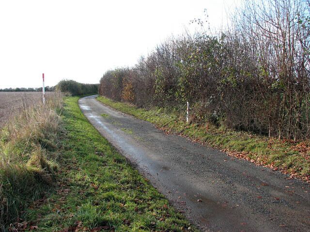 View along Belaugh Lane Which links Market Street with Belaugh Green further to the southwest. In mid-distance gas pipeline markers can be seen by the roadside.