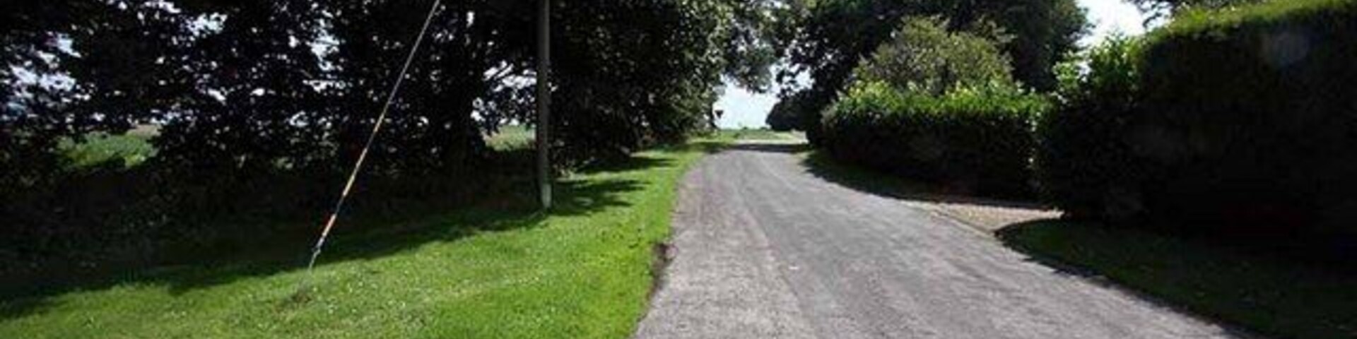 Road past Holy Trinity Church, Scoulton, Norfolk