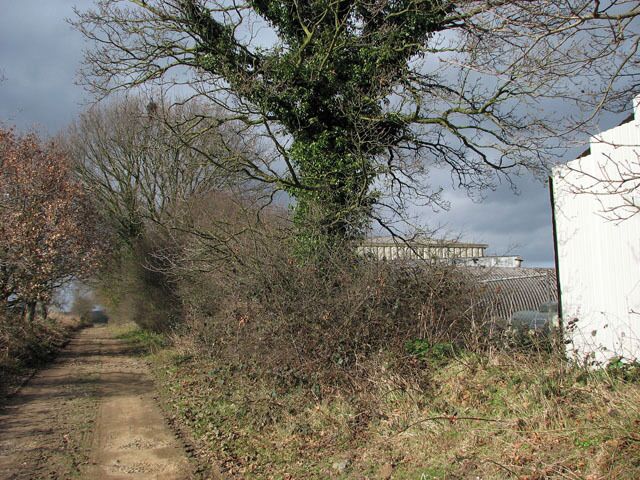 Track past Five Berries Farm This farm track which doubles as a public footpath links Short-Thorn Road with Brick Kiln Road, further to the north. The agricultural buildings seen at right belong to Five Berries Farm.