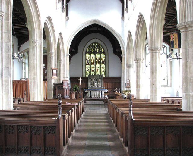 St Martin's Church - view east. St Martin's church > 1394663 was designed and built in one piece by architect Thomas Aldrych in the mid 15th century, using limestone in combination with knapped flint for the flushwork decoration. The south aisle was restored and enlarged in the 16th century when the roof height was raised. The present chancel was restored by Norwich architect Edward Boardman in Victorian times. The east window, which contains Kempe glass, was installed at the same time. The reredos > 1394692 is by H.B. Walters and dates from 1906. It is believed that the Easter Sepulchre > 1394691 once contained the remains of Alice Knyvet and the indent of a brass depicting a woman in prayer remains on the back wall of the tomb recess. The octagonal font bowl > 1394706 - it is dated 'Feb 1 1617' and inscribed with the name of the churchwardens - rests on a medieval shaft which is decorated with four lions, alternating with wild men. Four of the doors > 1394682 are original and several 15th century poppy-headed benches have survived in the nave. The church is open every day.