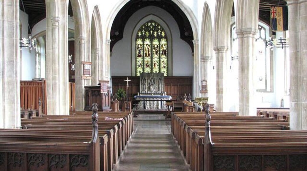 St Martin's Church - view east. St Martin's church > 1394663 was designed and built in one piece by architect Thomas Aldrych in the mid 15th century, using limestone in combination with knapped flint for the flushwork decoration. The south aisle was restored and enlarged in the 16th century when the roof height was raised. The present chancel was restored by Norwich architect Edward Boardman in Victorian times. The east window, which contains Kempe glass, was installed at the same time. The reredos > 1394692 is by H.B. Walters and dates from 1906. It is believed that the Easter Sepulchre > 1394691 once contained the remains of Alice Knyvet and the indent of a brass depicting a woman in prayer remains on the back wall of the tomb recess. The octagonal font bowl > 1394706 - it is dated 'Feb 1 1617' and inscribed with the name of the churchwardens - rests on a medieval shaft which is decorated with four lions, alternating with wild men. Four of the doors > 1394682 are original and several 15th century poppy-headed benches have survived in the nave. The church is open every day.