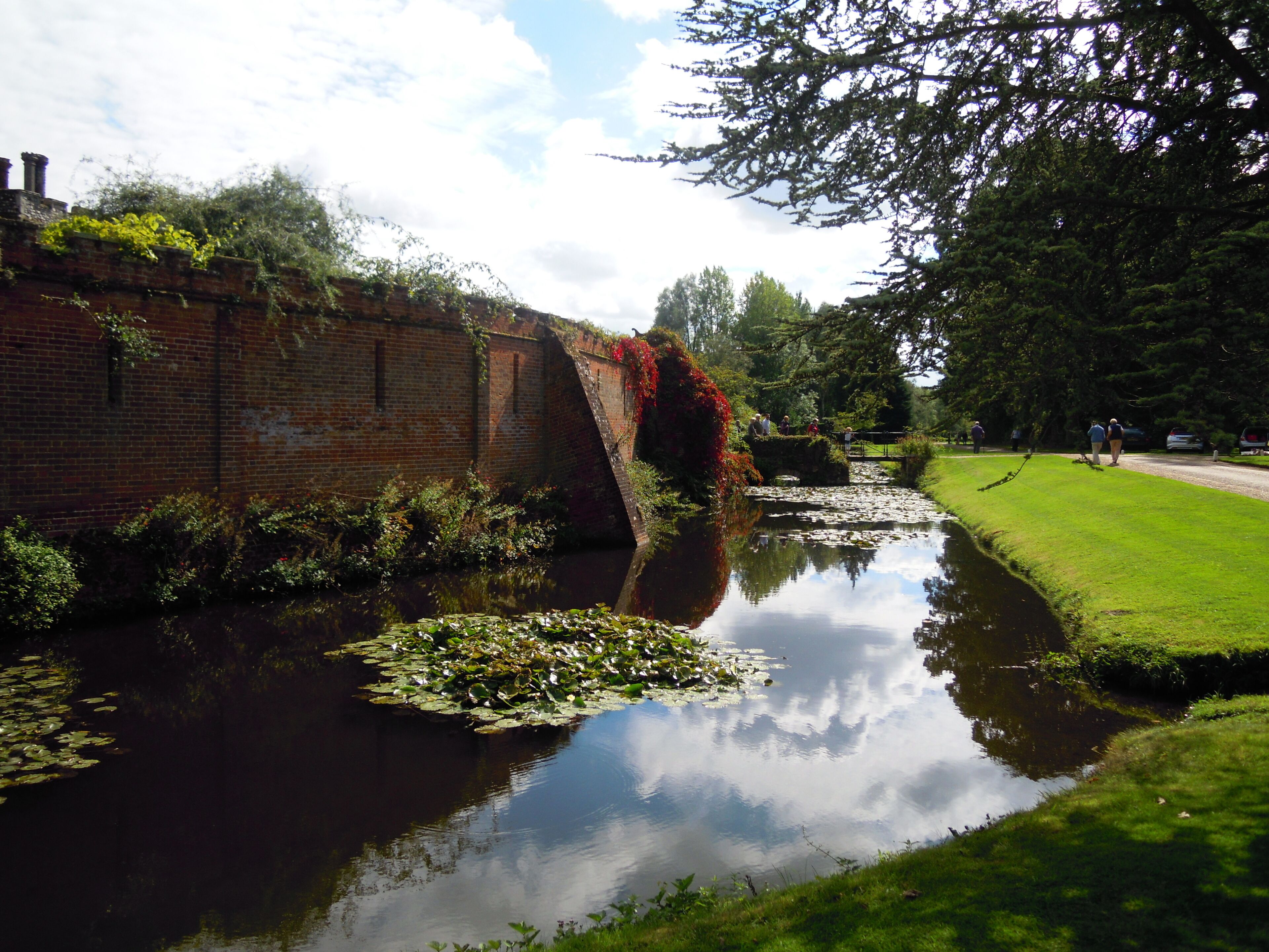The Western side of the moat around Mannington Hall viewed from the north east corner, Norfolk, United Kingdom