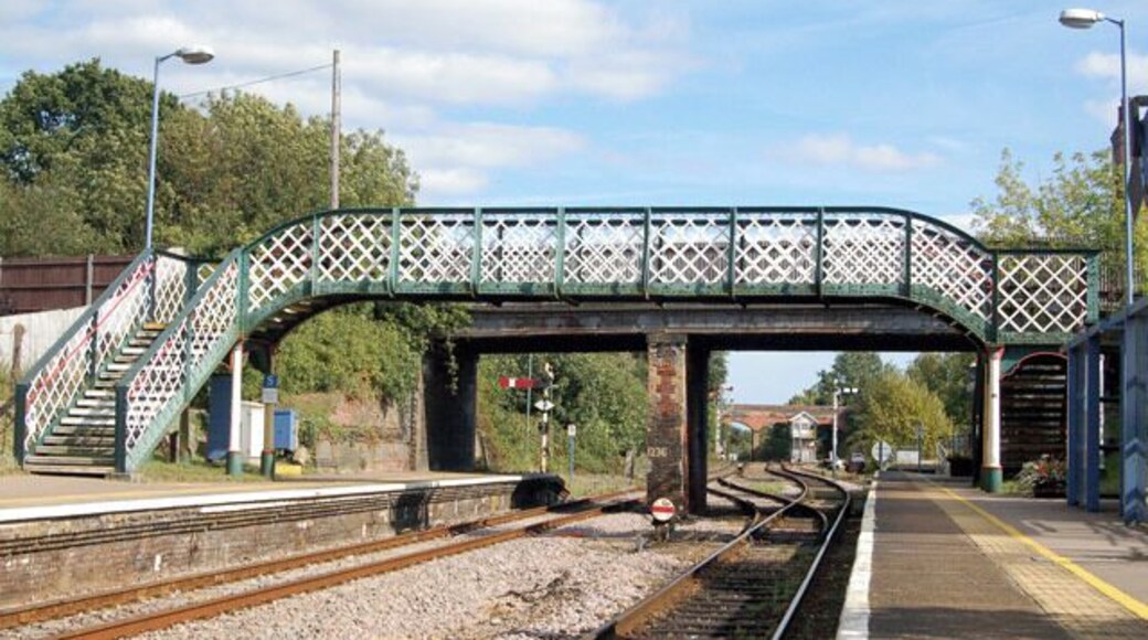 Reedham station photo-survey (12) Looking east along the up (Norwich-bound) platform in the down direction at Reedham railway station footbridge. Beyond the footbridge, a road bridge spans the station. The signal box is visible in the distance. Reedham station is on the ex-Great Eastern Rly route from Norwich to Lowestoft and is situated roughly mid-way between the two towns. Reedham station has two platforms, one for up (Norwich-bound) traffic and one for down (Yarmouth and Lowestoft) traffic. The majority of passenger services are operated by National Express. Half-a-mile east of the station is Reedham Junction; a single track route branches northeast to Yarmouth and the double track route continues southeast to Lowestoft. The junction is controlled by a traditional lever-frame signal box between the station and the junction itself.