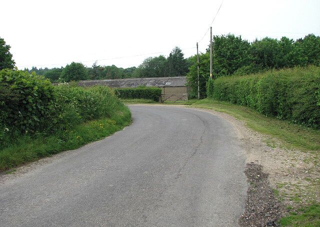 Sharp bend in Reepham Road. The long building seen in the background belongs to Manor Farm > 828895. The view is northwesterly.