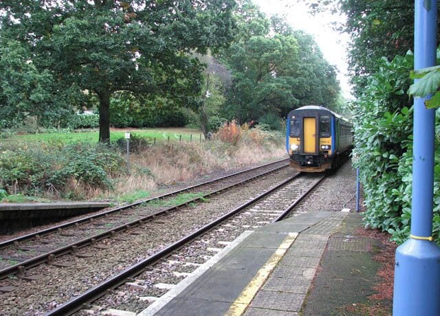Norwich-bound train passing Brundall Gardens station. Brundall Gardens station > 1531905 serves the western end of the village. It is located on the Wherry Lines and served by National Express East Anglia, linking Norwich with Great Yarmouth and Lowestoft. The entrance to the station is at the end of West End Avenue > 1531874 - an unsurfaced access road serving the properties situated alongside it. The station is unmanned and there is no car park. A footbridge > 1531893 connects the two platforms - it has the number 1225A.