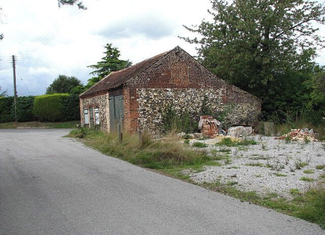 Flint and brick barn This building stands by the junction of The Green with Marsh Road.