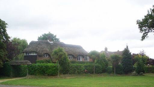 Thorpe End Garden Village Thorpe End was developed in the 1930s as a "Garden Village" by Percy and Leonard Howes of the Norwich estate agents Percy Howes and Co, who saw a potential market in the provision of new middle class houses, within easy commuting distance of the city, but in rural surroundings, and bought a site of 90 acres in open country straddling the Plumstead Road. Their brochure offered the ideal home at Thorpe End - house designs were not stipulated, but they had to be designed and built under the supervision of members of the Royal Institute of British Architects. The use of mellow bricks and thatched roofs was encouraged to lend the development an old-world character. The houses were to be built at a density of no more than three to the acre, all gardens having room for a tennis court, a quintessential thirties middle-class aspiration. Although later development has diluted these high ideals, much of the Garden Village has survived. This house, on the north east side of the central green, was occupied by Leonard Howes himself, and is one of the largest and most eleborately picturesque in the development.