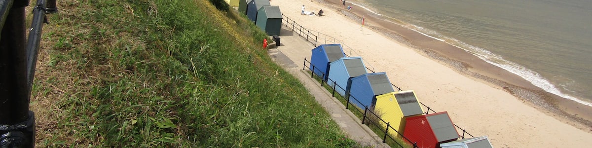 Looking north west along the promenade and Mundesley beach in the village of Mundesley, Norfolk, United Kingdom.