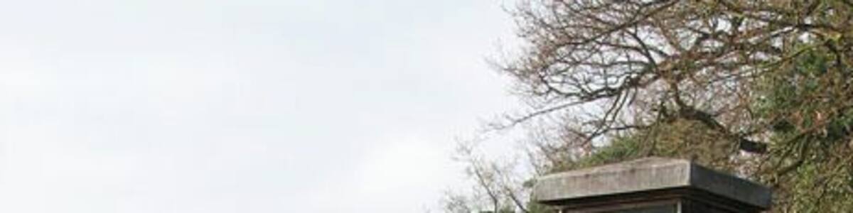 View west along Kirby Road past Bramerton village sign The village sign is situated on a small triangular green by the junction of Surlingham and Kirby Road.