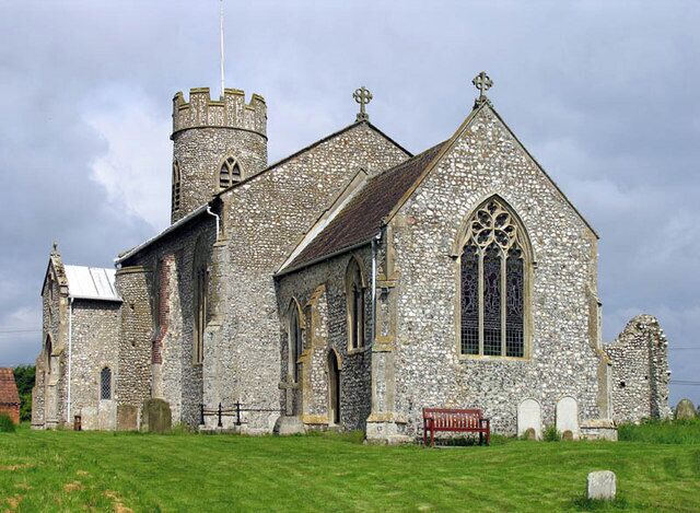 A historic stone church with a prominent tower and arched windows.