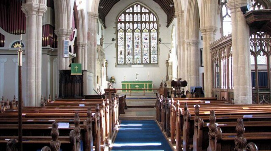 The church of SS Peter and Paul - view east. The church of SS Peter and Paul > 1702998 was built in the 15th century on the site of an older church. It has a magnificent hammerbeam roof which rises to a height of 45 feet above the floor. The building contains many other medieval survivals such as the panels of the chancel screen > 1703026 - an older screen surrounding the Lady Chapel with intricate carvings in its spandrels > 1703031 - choir stalls in the chancel > 1703049 - remains of a mural and the octagonal font > 1703053. There are also a number of interesting tombs. To members of the Lovell family on either side of the east window. To Anne, only child of Sir Robert Herling, on the north wall of the chancel > https://www.geograph.org.uk/photo/1703037. To Sir Robert Herling (d 1435) at the east end of the south aisle > https://www.geograph.org.uk/photo/1703041. To Sir Thomas Lovell and Dame Alice, his wife, with their crests (a bundle of peacock feathers and a Saracen's head) at their feet > https://www.geograph.org.uk/photo/1703043. The most noteworthy feature of the church, however, is the magnificent east window > https://www.geograph.org.uk/photo/1703014 which was donated to the church by Lady Anne Herling and her second husband, Sir Robert Wingfield, in around 1460. Removed for safety in Cromwell's time, the glass of this notable window was hidden in the attic of the since demolished East Harling Hall. When the manor was sold to Thomas Wright in 1736 he restored the glass to the church. It was removed once again during WWII and replaced and re-leaded in 1947.