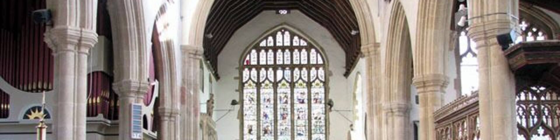 The church of SS Peter and Paul - view east. The church of SS Peter and Paul > 1702998 was built in the 15th century on the site of an older church. It has a magnificent hammerbeam roof which rises to a height of 45 feet above the floor. The building contains many other medieval survivals such as the panels of the chancel screen > 1703026 - an older screen surrounding the Lady Chapel with intricate carvings in its spandrels > 1703031 - choir stalls in the chancel > 1703049 - remains of a mural and the octagonal font > 1703053. There are also a number of interesting tombs. To members of the Lovell family on either side of the east window. To Anne, only child of Sir Robert Herling, on the north wall of the chancel > https://www.geograph.org.uk/photo/1703037. To Sir Robert Herling (d 1435) at the east end of the south aisle > https://www.geograph.org.uk/photo/1703041. To Sir Thomas Lovell and Dame Alice, his wife, with their crests (a bundle of peacock feathers and a Saracen's head) at their feet > https://www.geograph.org.uk/photo/1703043. The most noteworthy feature of the church, however, is the magnificent east window > https://www.geograph.org.uk/photo/1703014 which was donated to the church by Lady Anne Herling and her second husband, Sir Robert Wingfield, in around 1460. Removed for safety in Cromwell's time, the glass of this notable window was hidden in the attic of the since demolished East Harling Hall. When the manor was sold to Thomas Wright in 1736 he restored the glass to the church. It was removed once again during WWII and replaced and re-leaded in 1947.