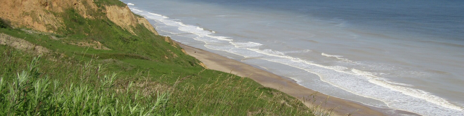 Looking westwards along the coast towards Overstrand from the cliff top in the village of Trimingham, Norfolk, United Kingdom.