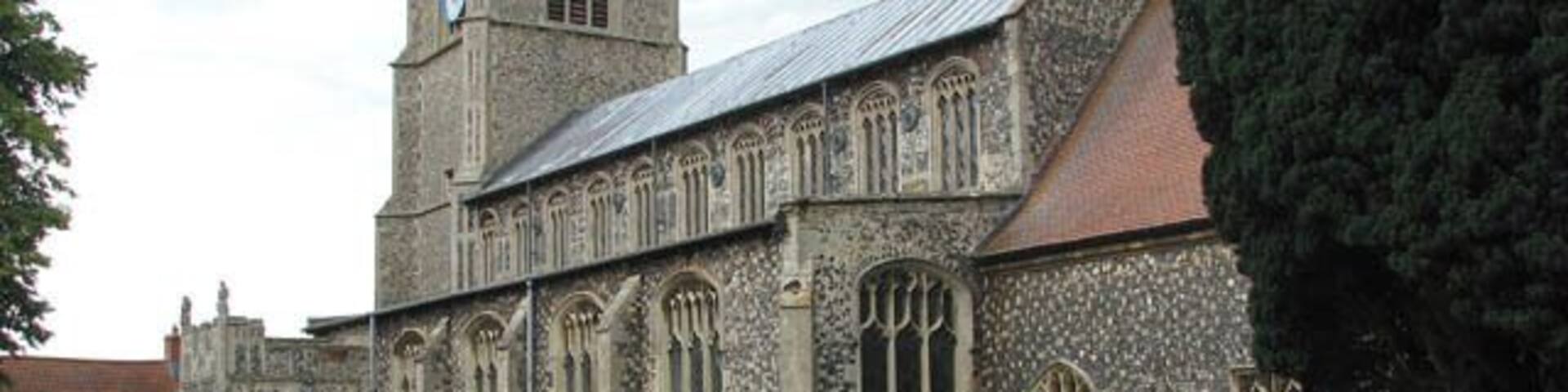 A historic church with a tall tower and arched windows.