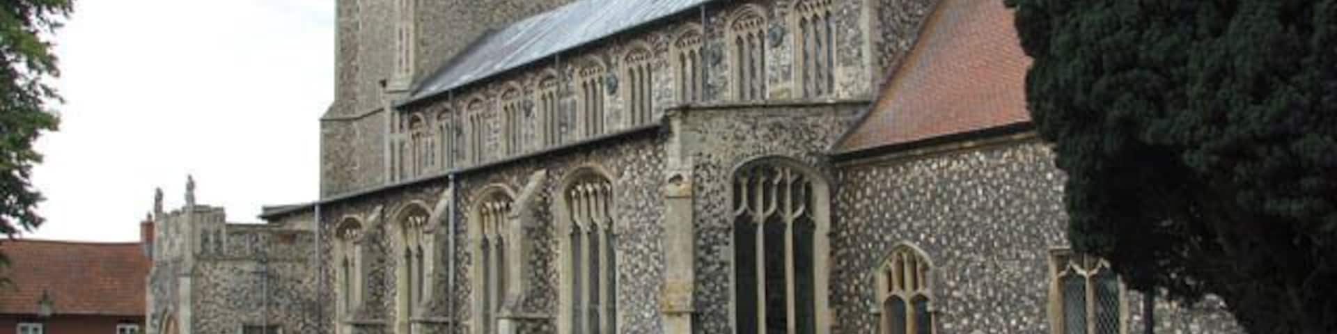 A historic church with a tall tower and arched windows.