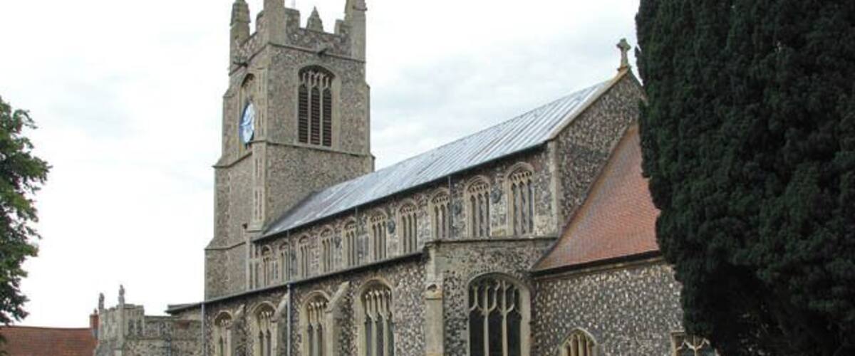 A historic church with a tall tower and arched windows.