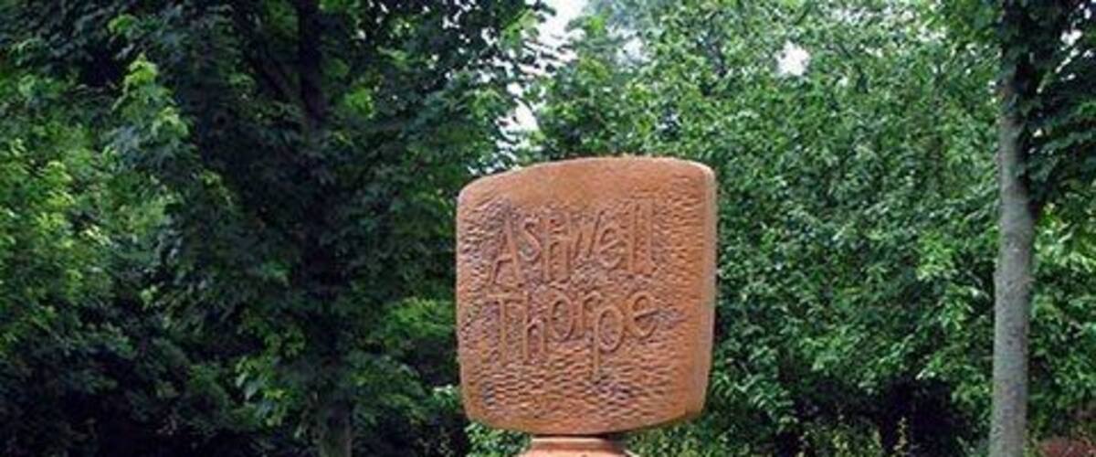 Village sign outside All Saints Church, Ashwelthorpe, Norfolk