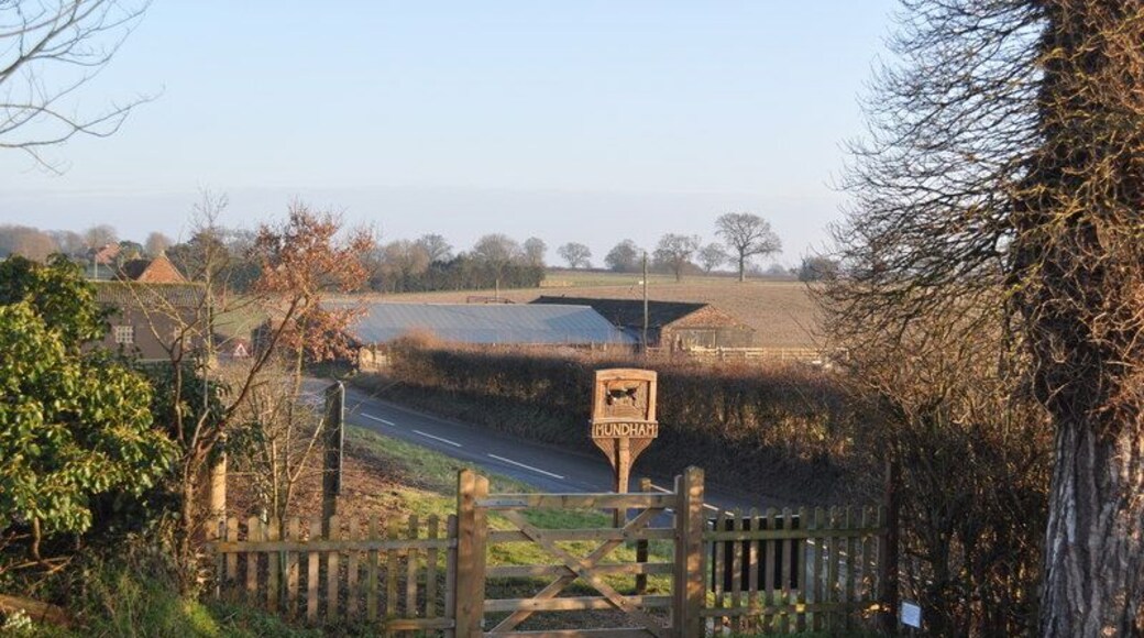 Mundham Village sign Looking at the Mundham village sign from the churchyard.Along with Lower hall farm, the buildings are undergoing restoration/demolition/conversion.