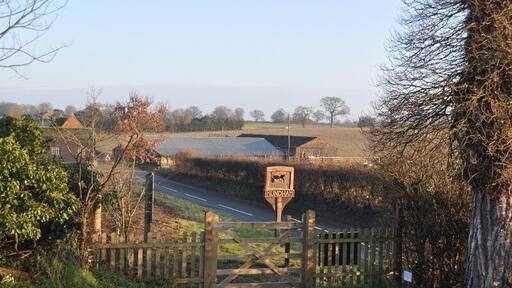 Mundham Village sign Looking at the Mundham village sign from the churchyard.Along with Lower hall farm, the buildings are undergoing restoration/demolition/conversion.