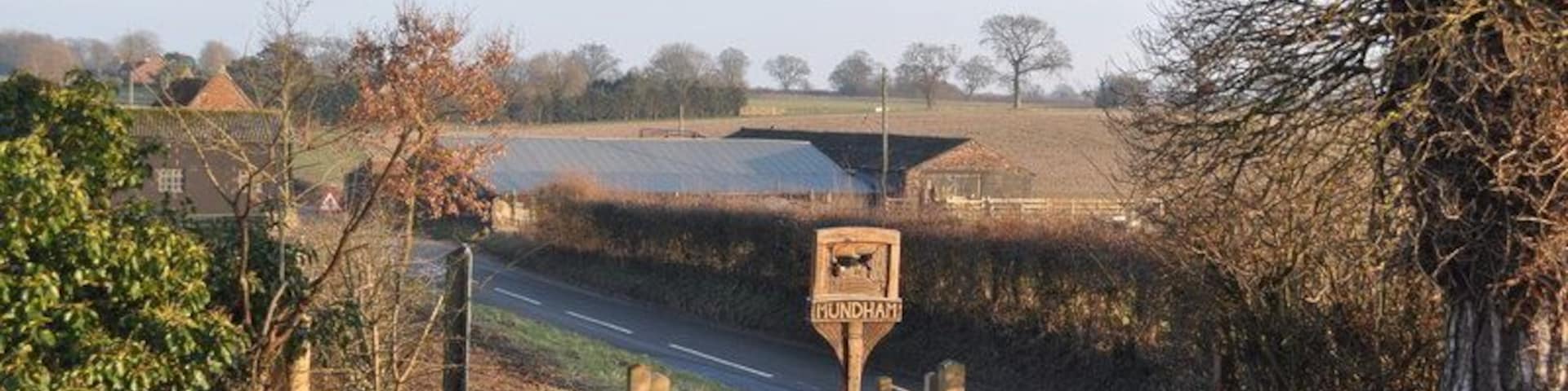 Mundham Village sign Looking at the Mundham village sign from the churchyard.Along with Lower hall farm, the buildings are undergoing restoration/demolition/conversion.