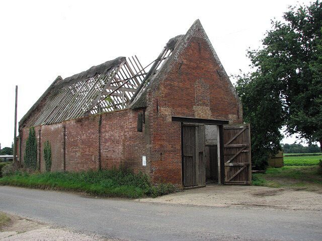 Roofless old red-brick barn. See also > 911164. Through the open door scaffolding and bundles of reeds, ready for thatching, could be glimpsed inside.