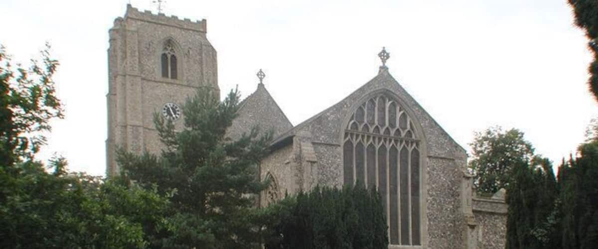 A church with a tall tower and a large window.