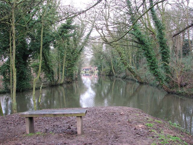 Seat by the end of the path This seat is situated where a drain which runs parallel with Whitlingham Lane empties into the River Yare, for the walker to enjoy the view before returning back. The path starts by the junction of Whitlingham Lane and Bracondale, opposite St Andrew's church > https://www.geograph.org.uk/photo/1670592. It leads in northerly direction, following the course of a drain which flows parallel with and empties into the River Yare. The meadow which the path traverses is bordered by Whitlingham Lane in the east. The lane can be accessed via stile and wooden steps > https://www.geograph.org.uk/photo/1671067.