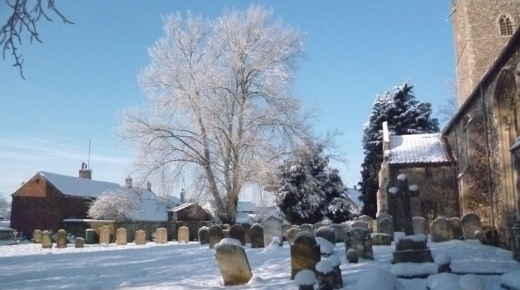Part of St Margaret's parish churchyard, Lyng, Norfolk, England, in snow in January 2013