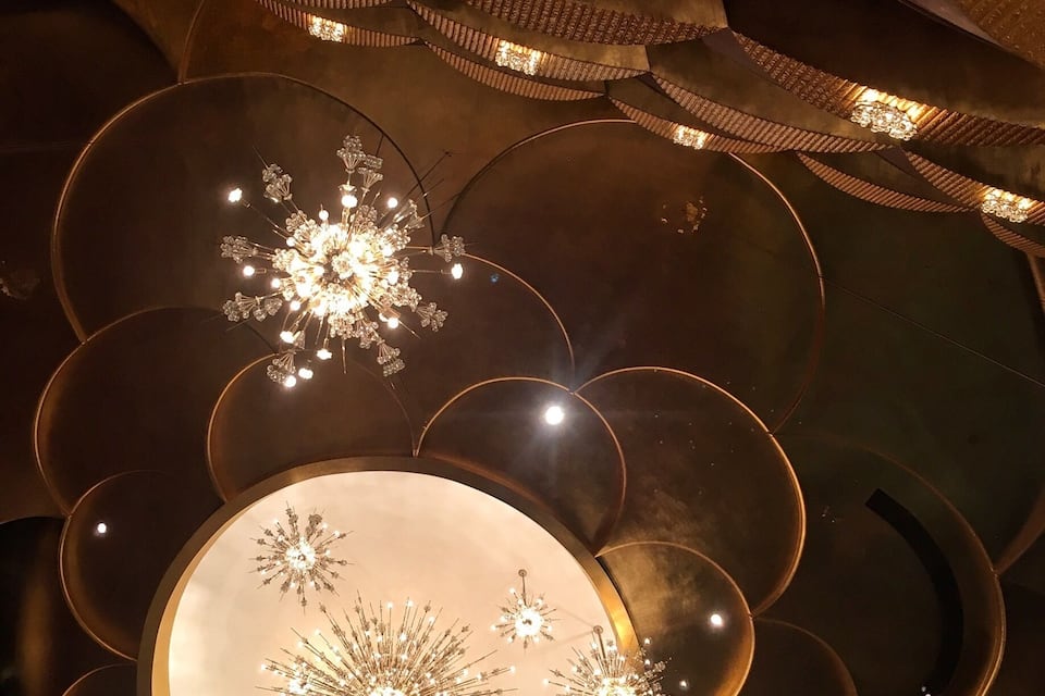 A ceiling with circular patterns and star-shaped lights.