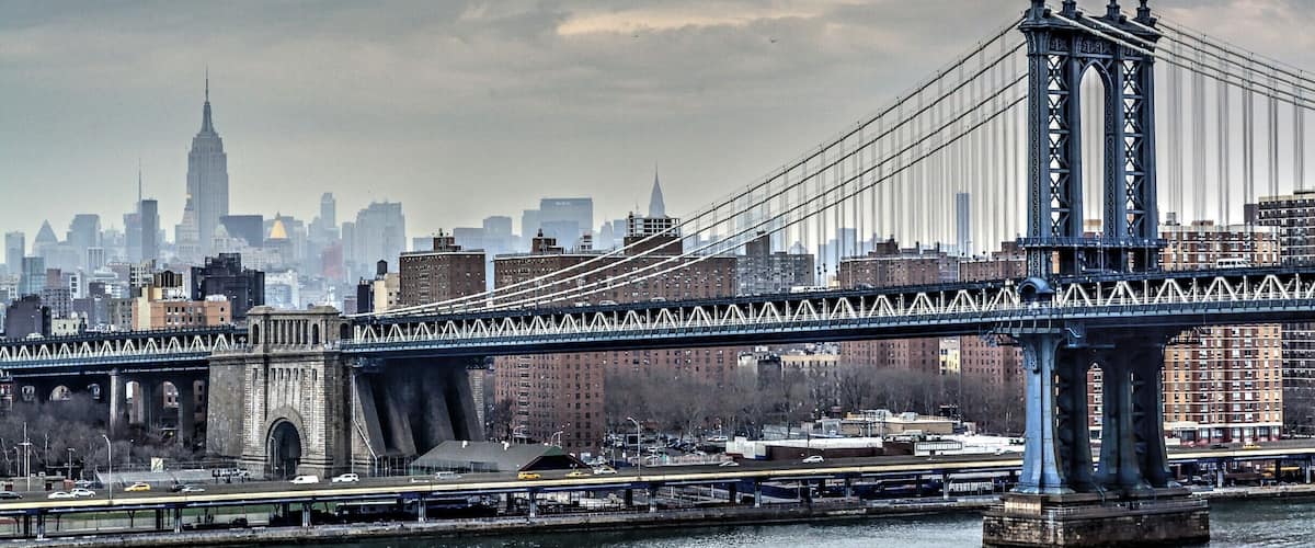 The Brooklyn Bridge with the Manhattan skyline in the background.