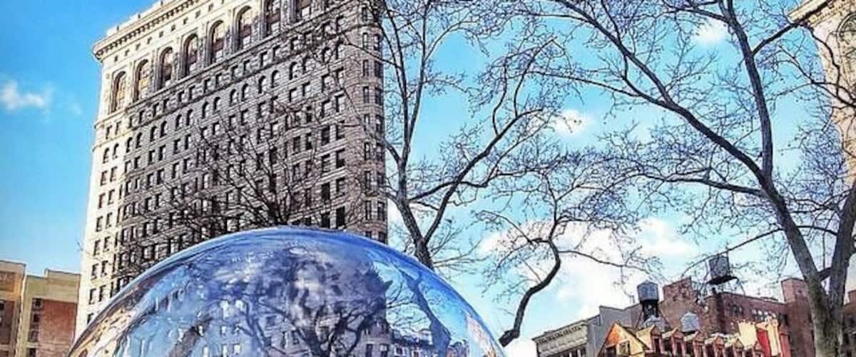 Gazing Globes installation by Paula Hayes at Madison Square Park with Flatiron Building in the background