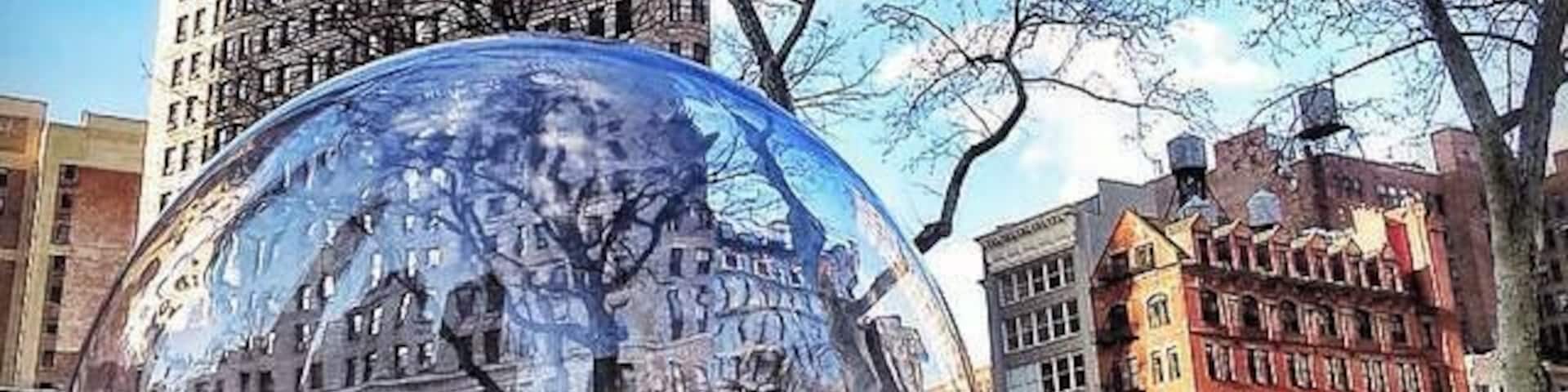 Gazing Globes installation by Paula Hayes at Madison Square Park with Flatiron Building in the background