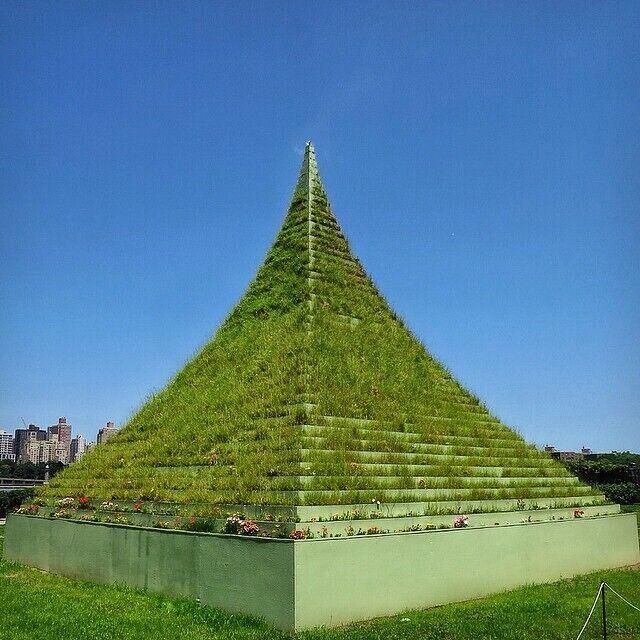 The Living Pyramid by Agnes Denes at the Socrates Sculpture park in Long Island City with the Manhattan skyline in the background