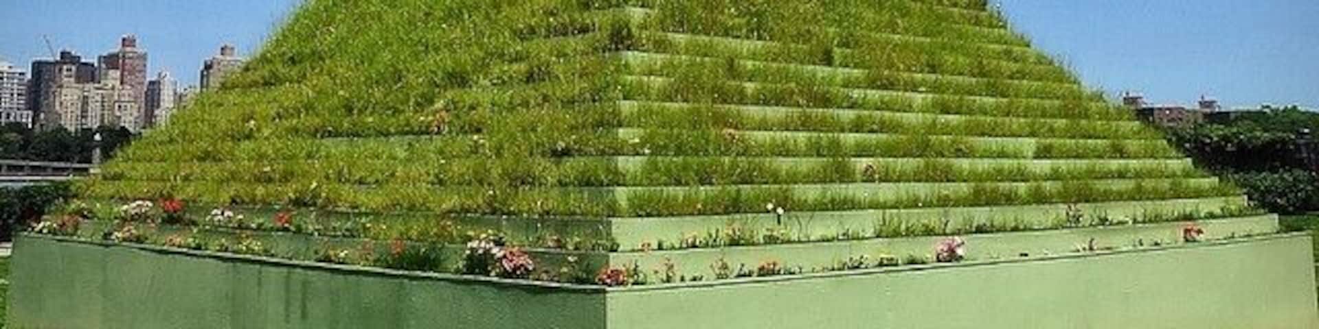 The Living Pyramid by Agnes Denes at the Socrates Sculpture park in Long Island City with the Manhattan skyline in the background