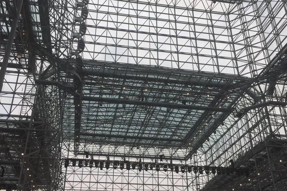 A large metal framework with a glass ceiling, likely part of a building's interior.
