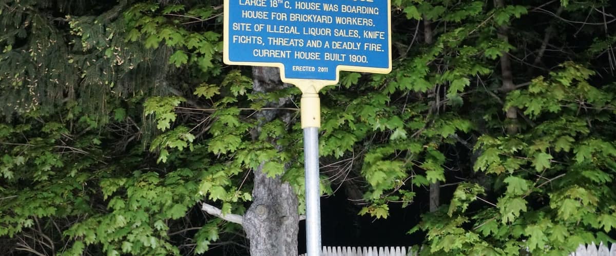A historical marker sign about The Osterby House, detailing its history and current status.