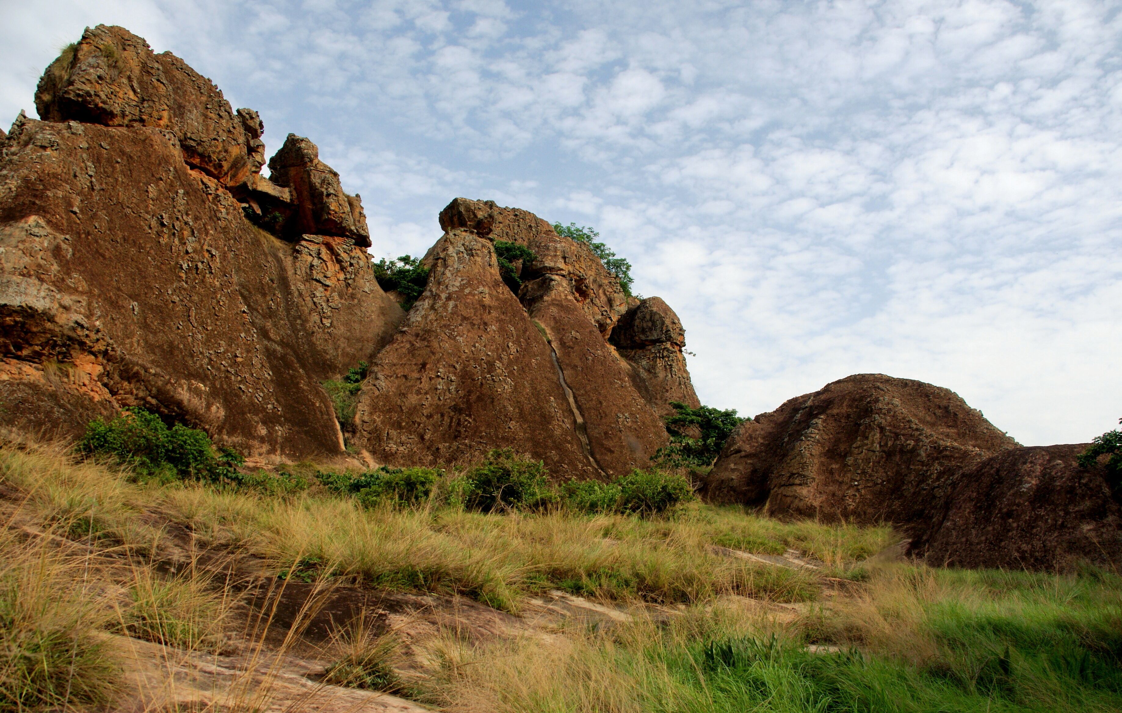 A rugged landscape with prominent rock formations and sparse vegetation.