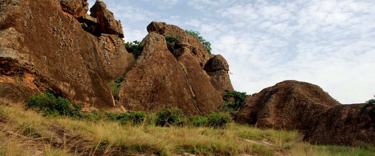 A rugged landscape with prominent rock formations and sparse vegetation.