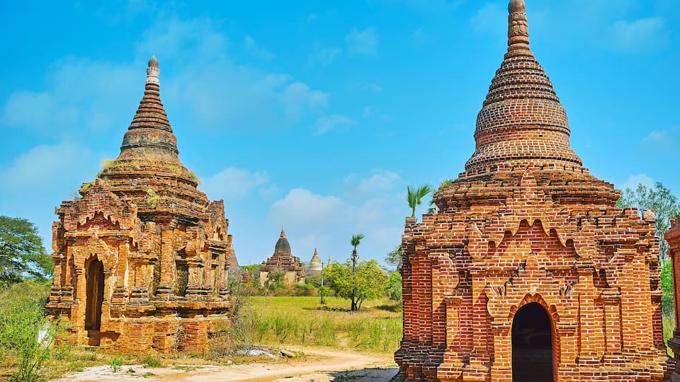 Ancient brick pagodas in a rural setting.