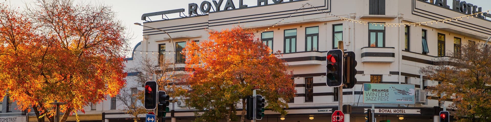 Orange featuring heritage elements, a small town or village and a sunset