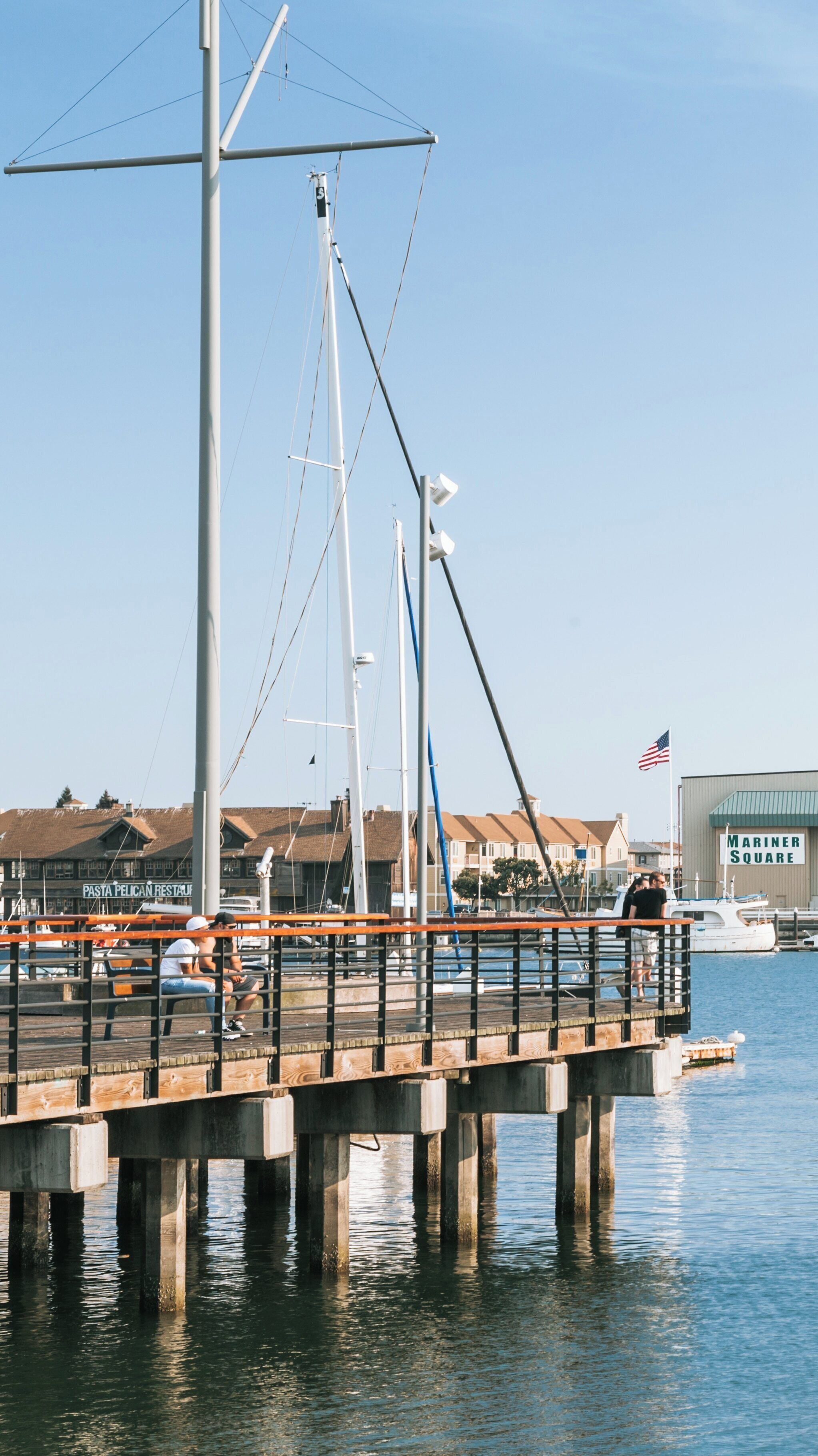 Exploring Jack London Square in downtown Oakland, California with waterfront views and sailboats under a clear sky