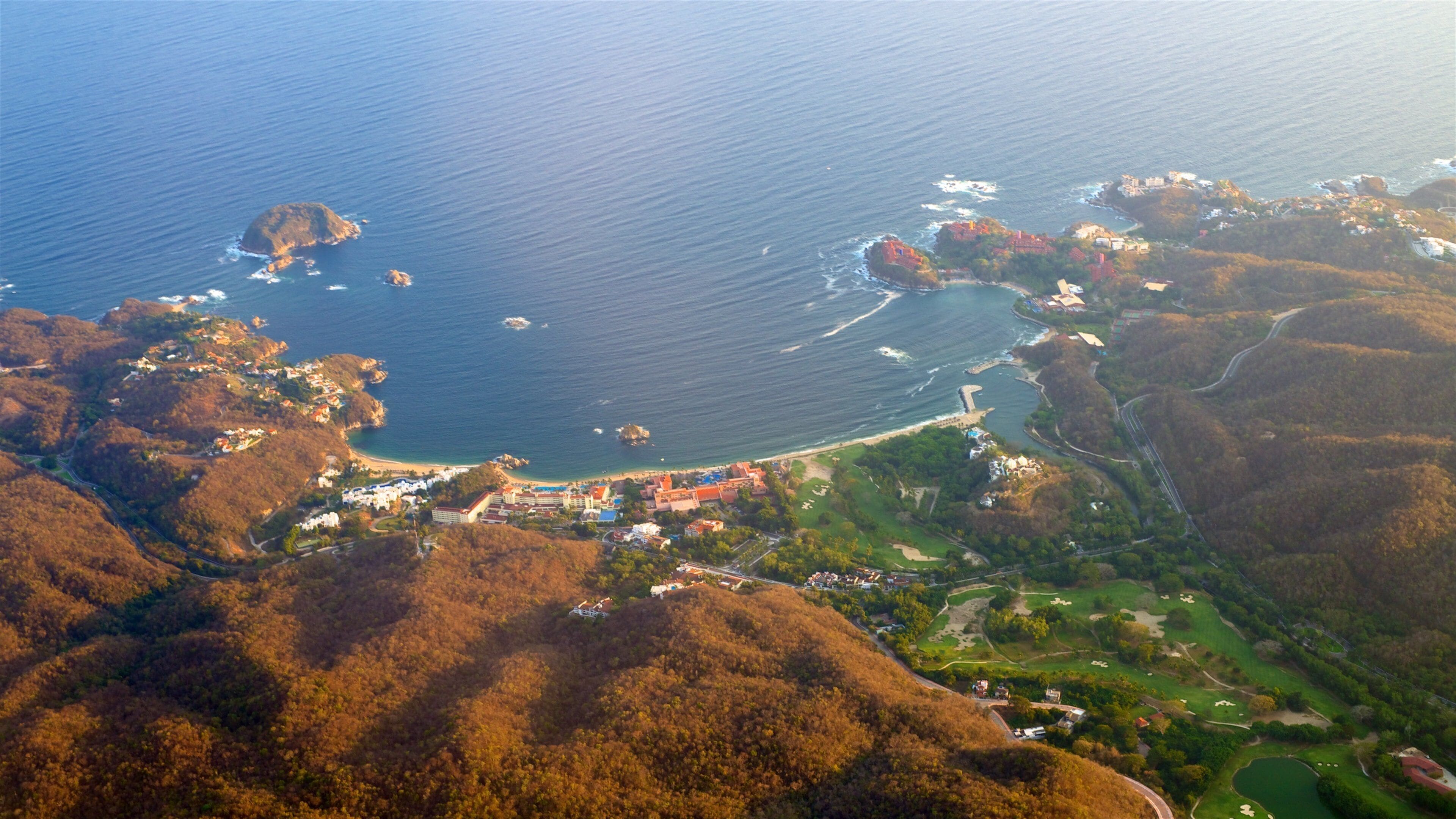 Oaxaca featuring a bay or harbor, a beach and rocky coastline