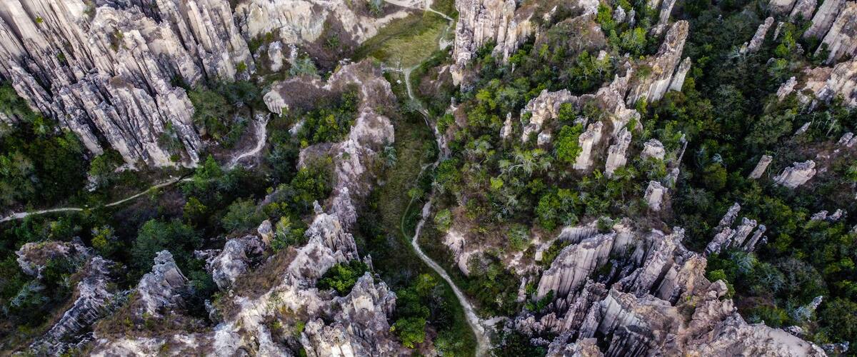 A rugged canyon landscape with steep cliffs and a winding path.
