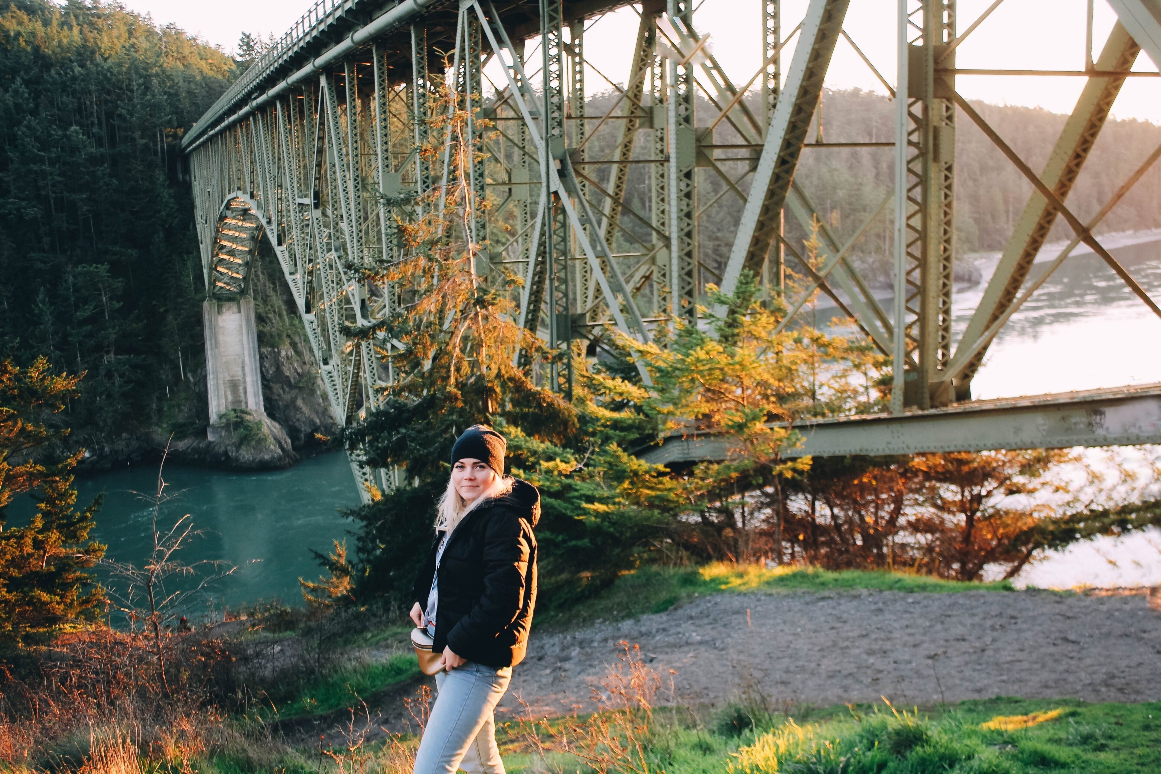  Girl hipster traveler on the ocean coast Deception Pass Bridge.  Washington State, USA
