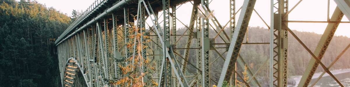 Girl hipster traveler on the ocean coast Deception Pass Bridge. Washington State, USA