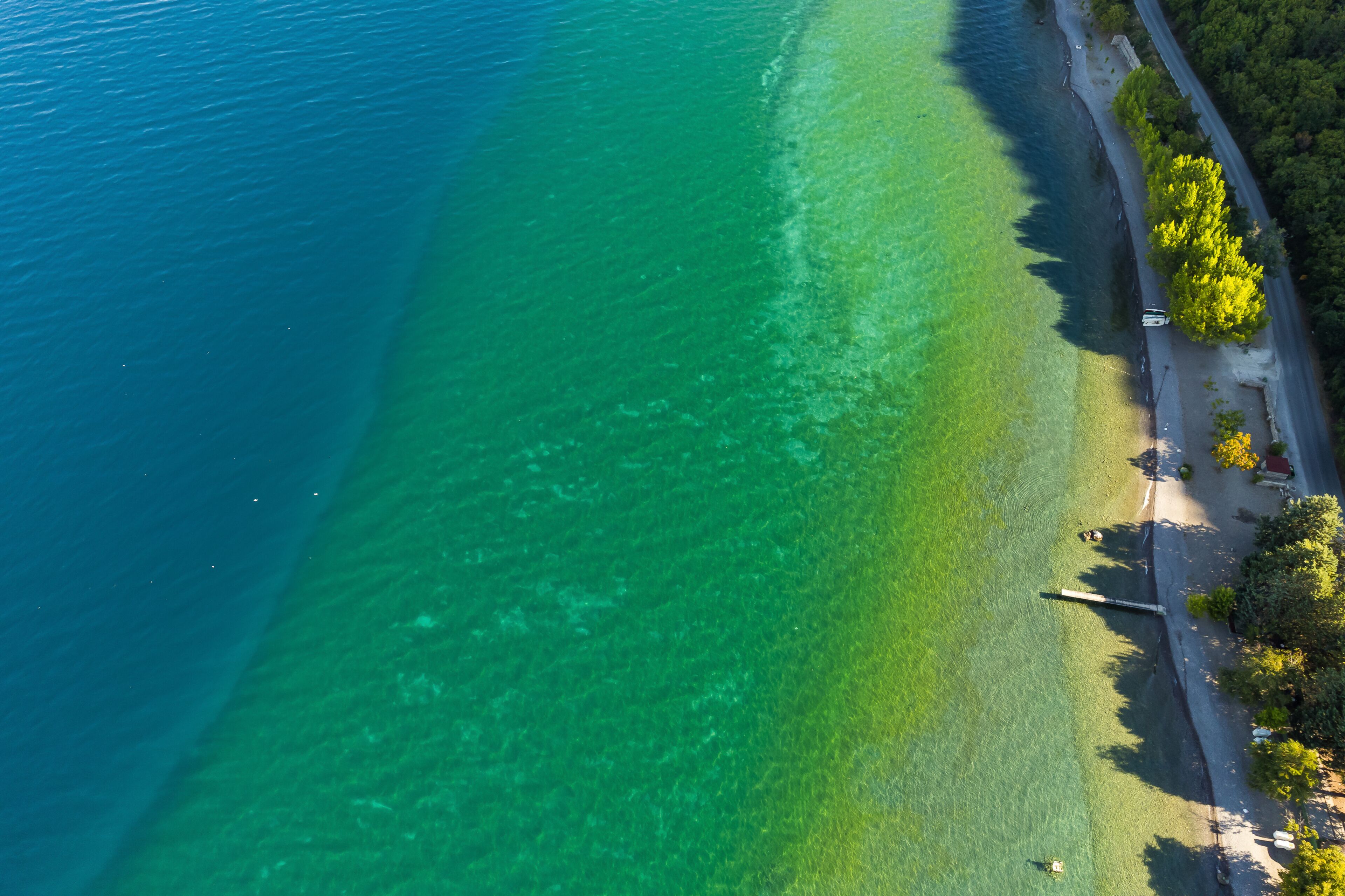 Different colors of blue in Ohrid lake in Summer of bird view